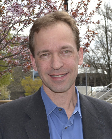 Headshot of John Spencer