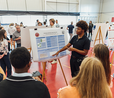 Biology student present their research findings in Floy Lewis Bakes Center. Part of CoSA 2024 | April 24, 2024