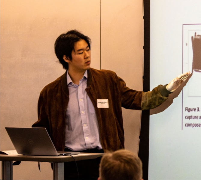 Student presenting a presentation to audience.