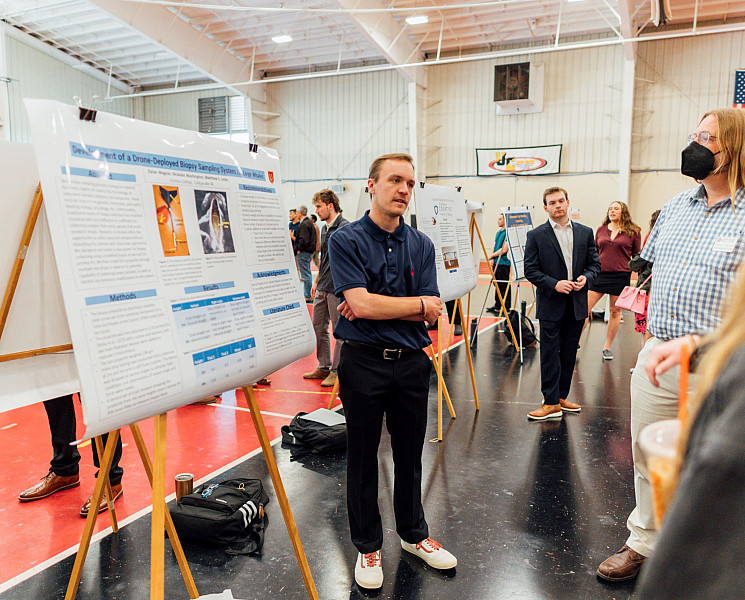 Marine science student presenting research to others.