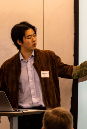 Student presenting a presentation to audience.