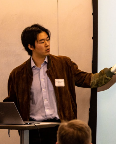 Student presenting a presentation to audience.