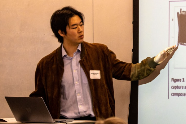 Student presenting a presentation to audience.