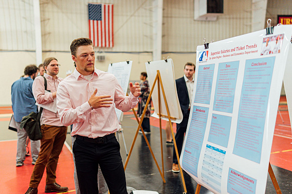 Economic student presenting research to others.