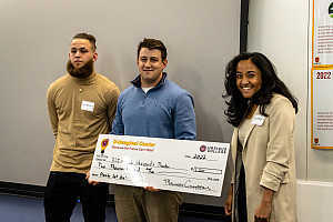 Aaron Diamond '22 & Mekha Varghese receiving their check from Judge, Brandon Dowd