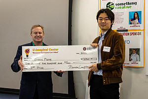 Sung Kim '23 receiving his check from Judge, Chris Biddle