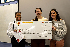 Maia Peele '23 & Julia Paiano '23 receving their check from Judge, Jen Crompton
